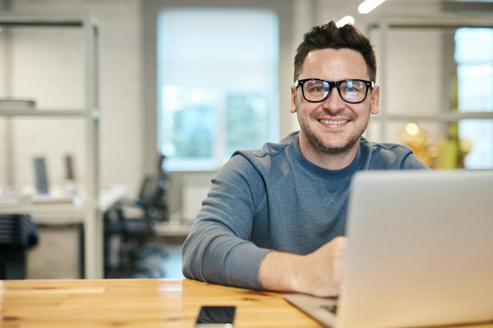 A software engineer writing code in a modern office