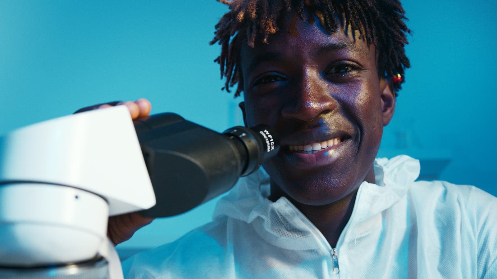 A researcher smiling at the camera